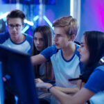 Photo of students working with their game development